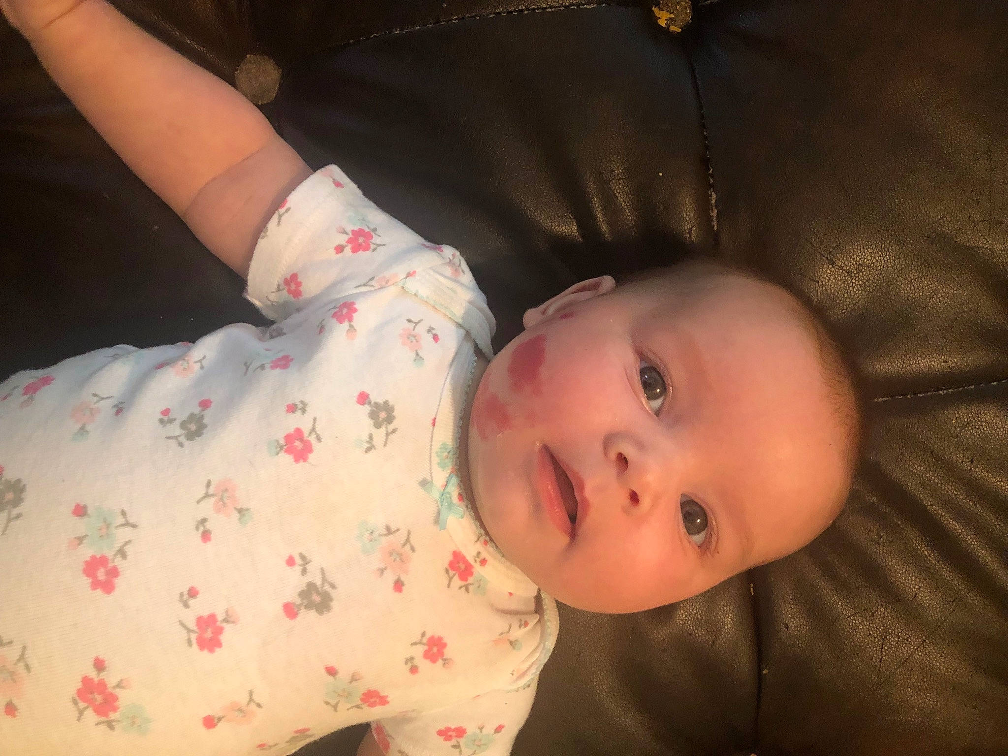 Delaney is registered to the contest to win money with this photo: arm, baby, baby_toddler_clothing, cheek, child, comfort, elbow, finger, gesture, human, lip, mouth, nose, pattern, person, sitting, skin, sleeve, smile, textile