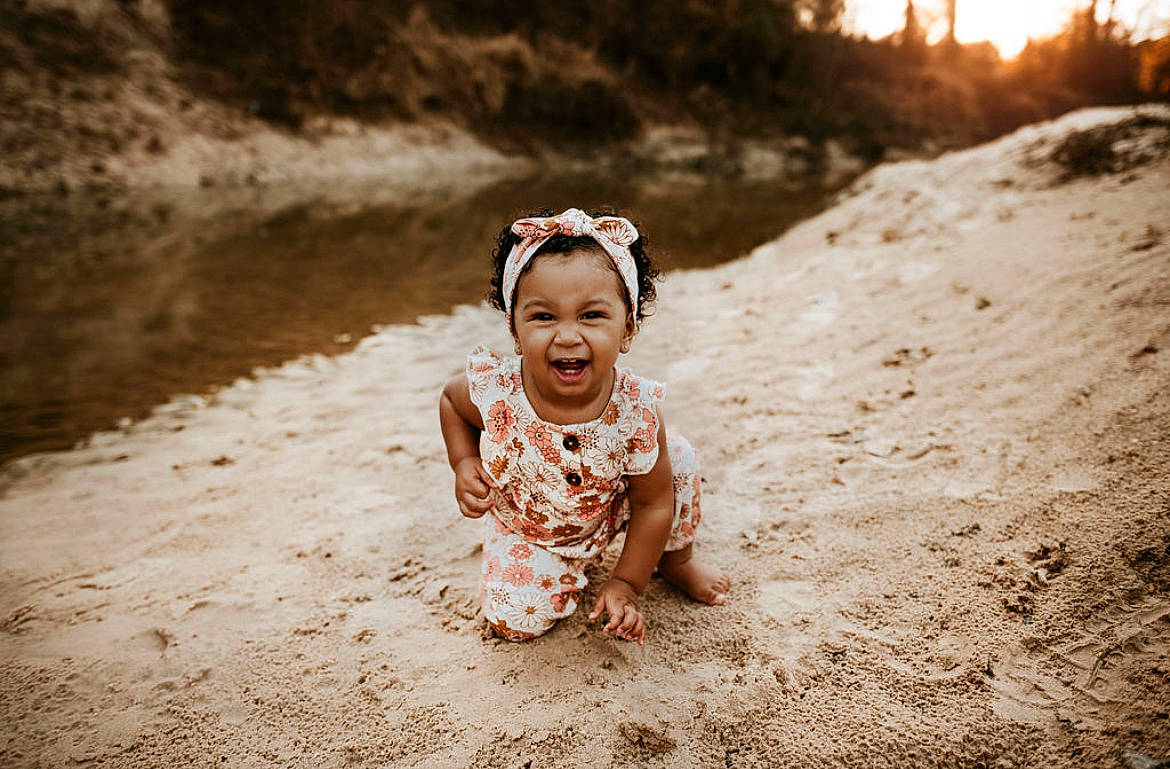 Alianna is registered to the contest to win money with this photo: beach, dress, eye, face, flash_photography, fun, grass, happy, head, human_body, landscape, leisure, monochrome_photography, people_in_nature, person, sand, smile, sunlight, toddler, tree