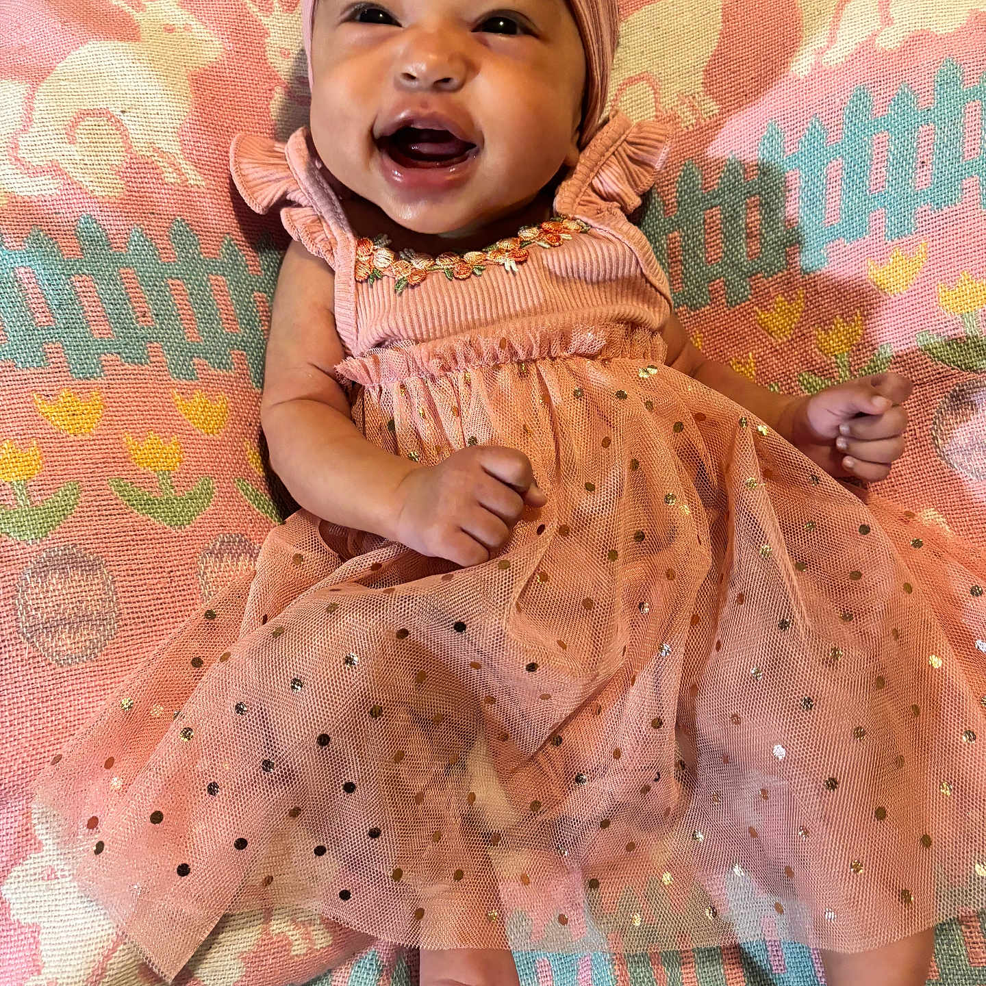 Tamera joined the competition — help win amazing prizes! adorable, baby, blanket, child, clothing, cute, happy, headband, indoor, infant, lying_down, patterned_blanket, pink_dress, portrait, rabbit_pattern, small_feet, small_hands, smiling, sparkly, toddler