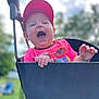Audrey is registered to the contest to win money with this photo: baby, child, swing, outdoor, playground, happy, smiling, cap, red_cap, pink_shirt, toy, necklace, daylight, nature, greenery, face, hand, person, joyful, fun