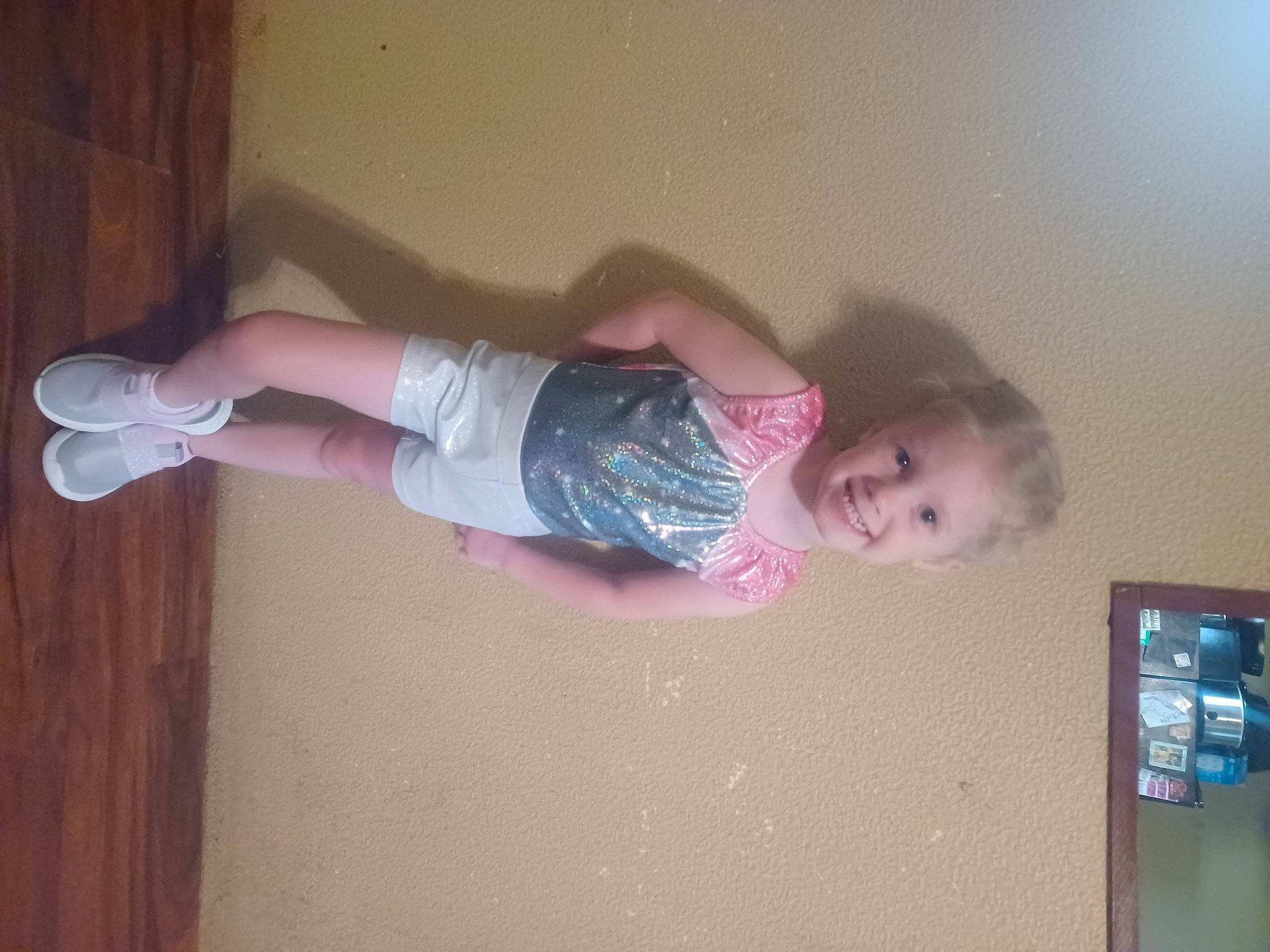 Amarah is registered to the contest to win money with this photo: baby, baby_toddler_clothing, cheek, child, finger, flooring, fun, hardwood, human_leg, joy, knee, leg, magenta, person, pink, room, skin, sock, t_shirt, thigh