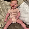 baby, infant, smiling, onesie, couch, blanket, indoor, child, happy, person, seated, cute, skin, head, face, legs, furniture, cozy, comfortable, young