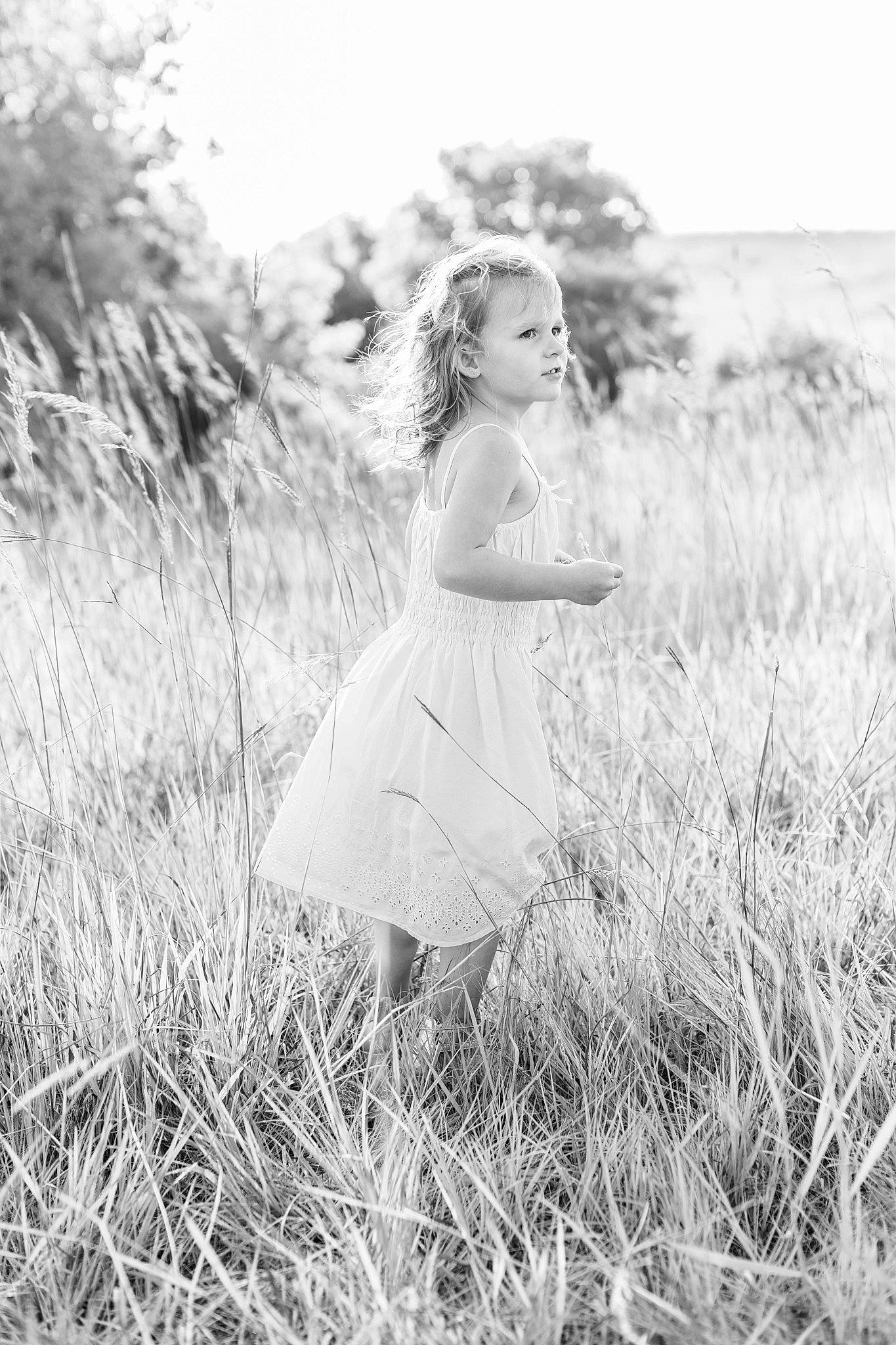 Addison is registered to the contest to win money with this photo: dress, field, flash_photography, gesture, grass, grass_family, grassland, happy, landscape, long_hair, meadow, monochrome, monochrome_photography, people_in_nature, person, plant, prairie, sky, standing, style