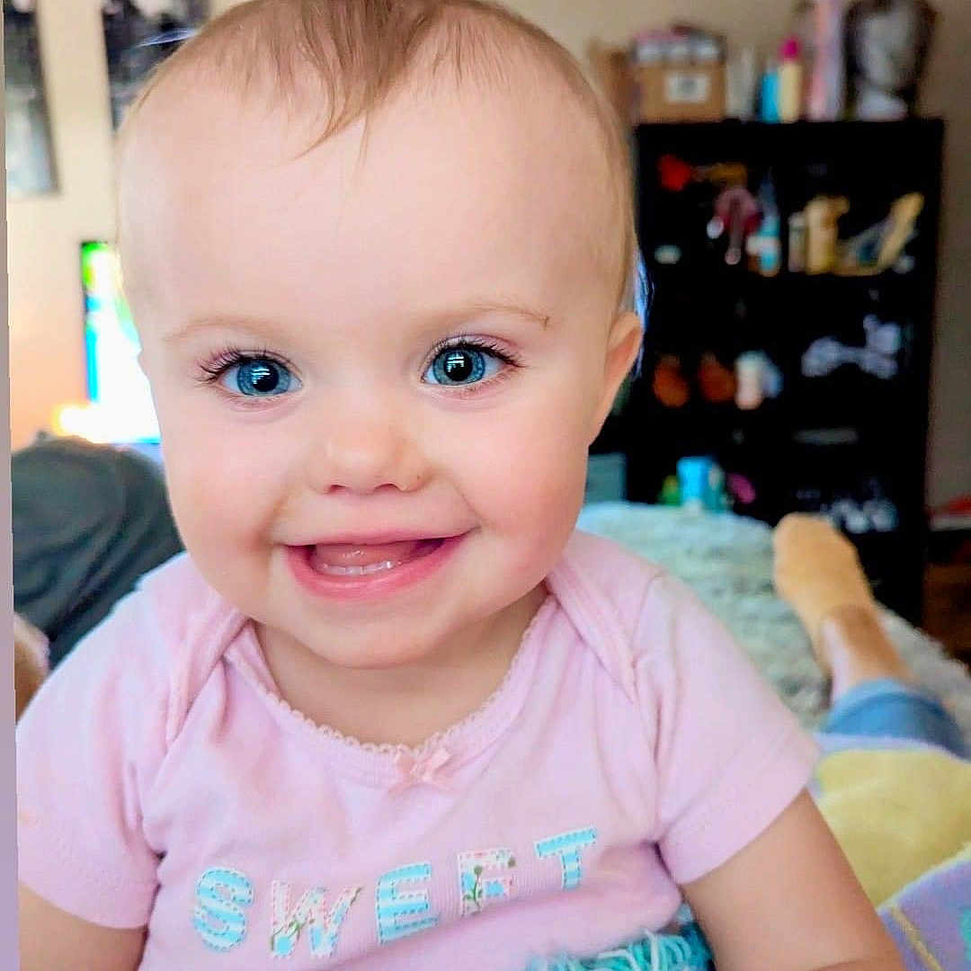 Everleigh joined the competition — help win amazing prizes! architecture, baby, babylaughing, bodypart, building, clothing, face, furniture, happy, head, indoors, laughing, livingroom, mouth, person, photography, portrait, smile, t_shirt, teeth