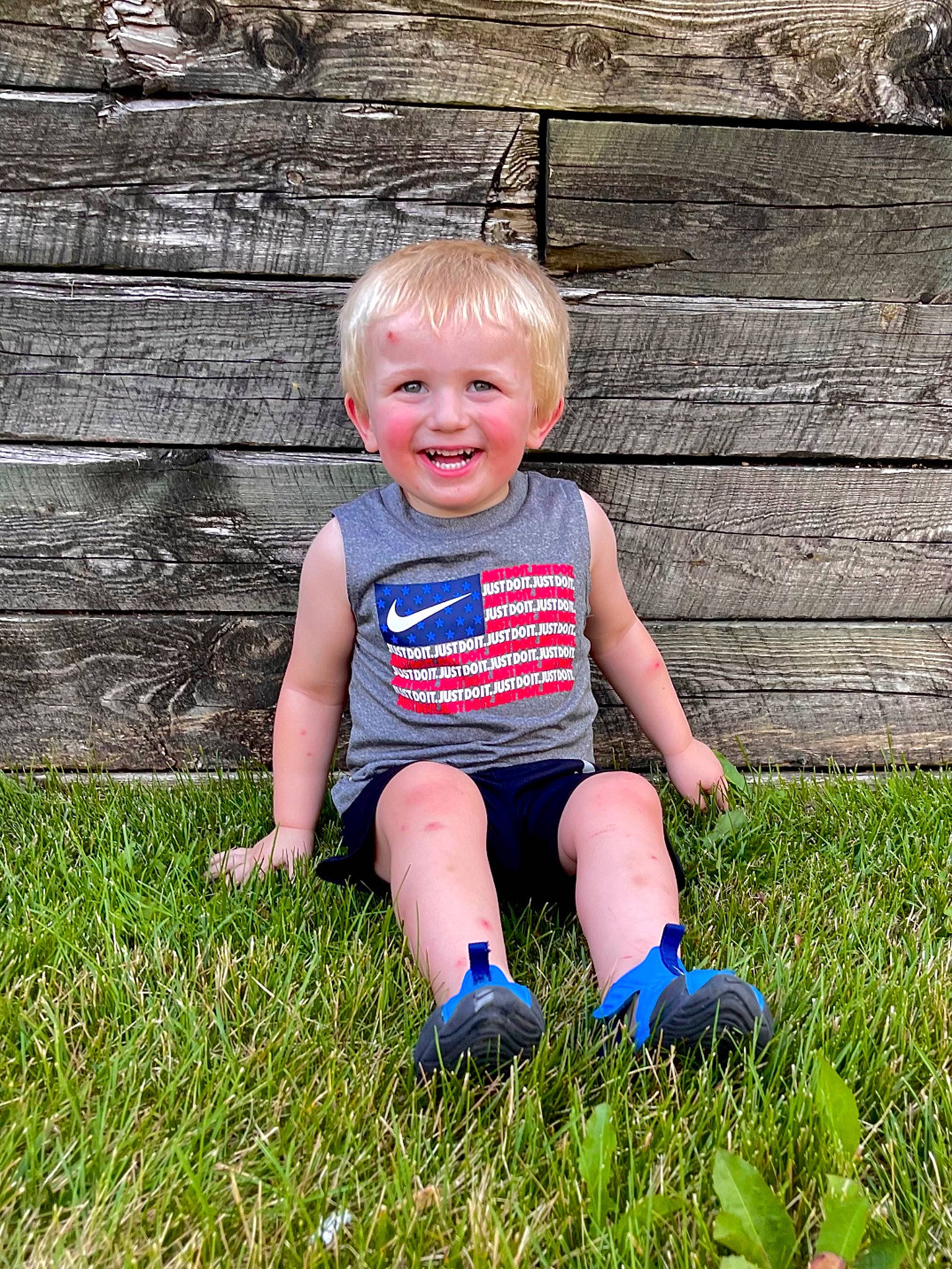 Bentley is registered to the contest to win money with this photo: baby, baby_toddler_clothing, child, electric_blue, eye, garden, grass, grassland, happy, head, joy, lawn, leisure, people_in_nature, person, plant, recreation, sitting, smile, t_shirt
