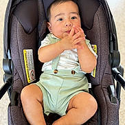 Kenai joined the competition — help win amazing prizes! baby, child, car_seat, infant, clothing, romper, suspenders, hand_gesture, cute, indoors, seat, person, young_child, portrait, comfortable, baby_clothes, looking_away, cushion, soft_light, casual