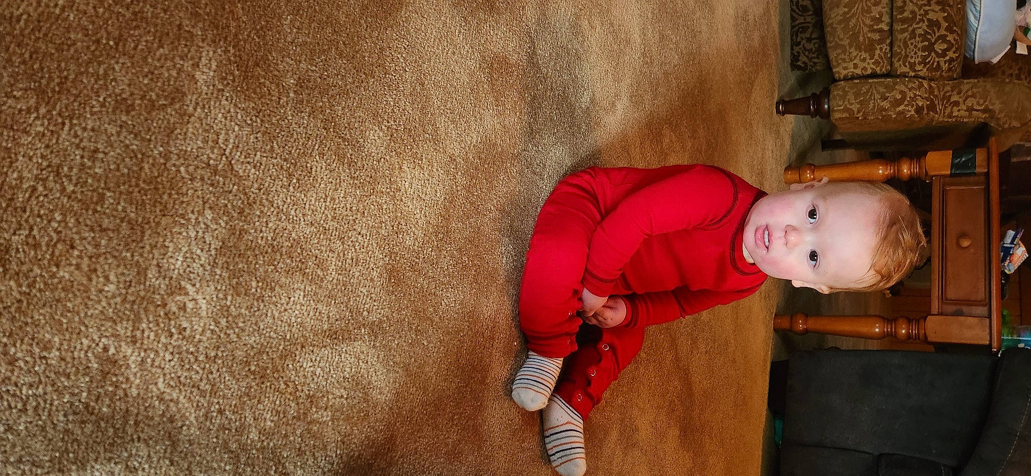 Jorah is registered to the contest to win money with this photo: baby, baby_toddler_clothing, carmine, child, comfort, couch, elbow, flooring, fun, human_leg, knee, magenta, mammal, orange, person, sitting, sleeve, sock, thigh, toddler