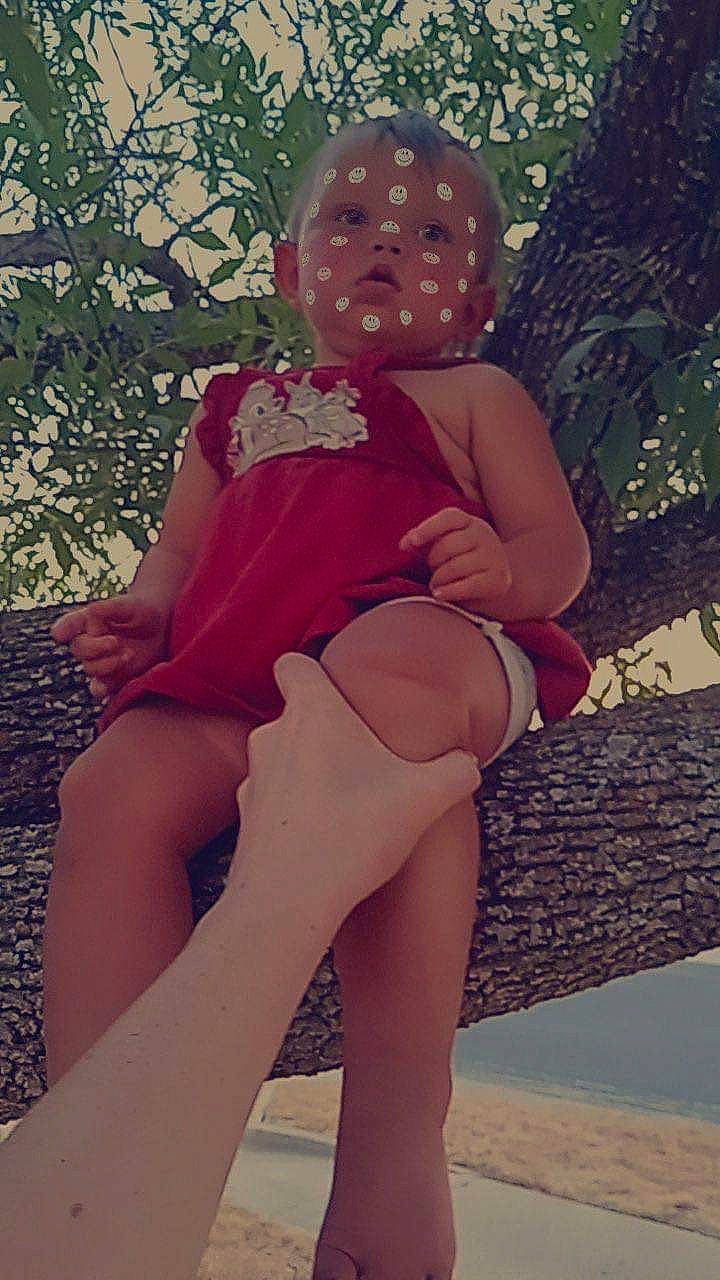 Skyler is registered to the contest to win money with this photo: abdomen, blond, brown_hair, chest, finger, foot, grass, hairstyle, human_leg, knee, leg, long_hair, person, pink, plant, shoulder, thigh, toy, trunk, undergarment