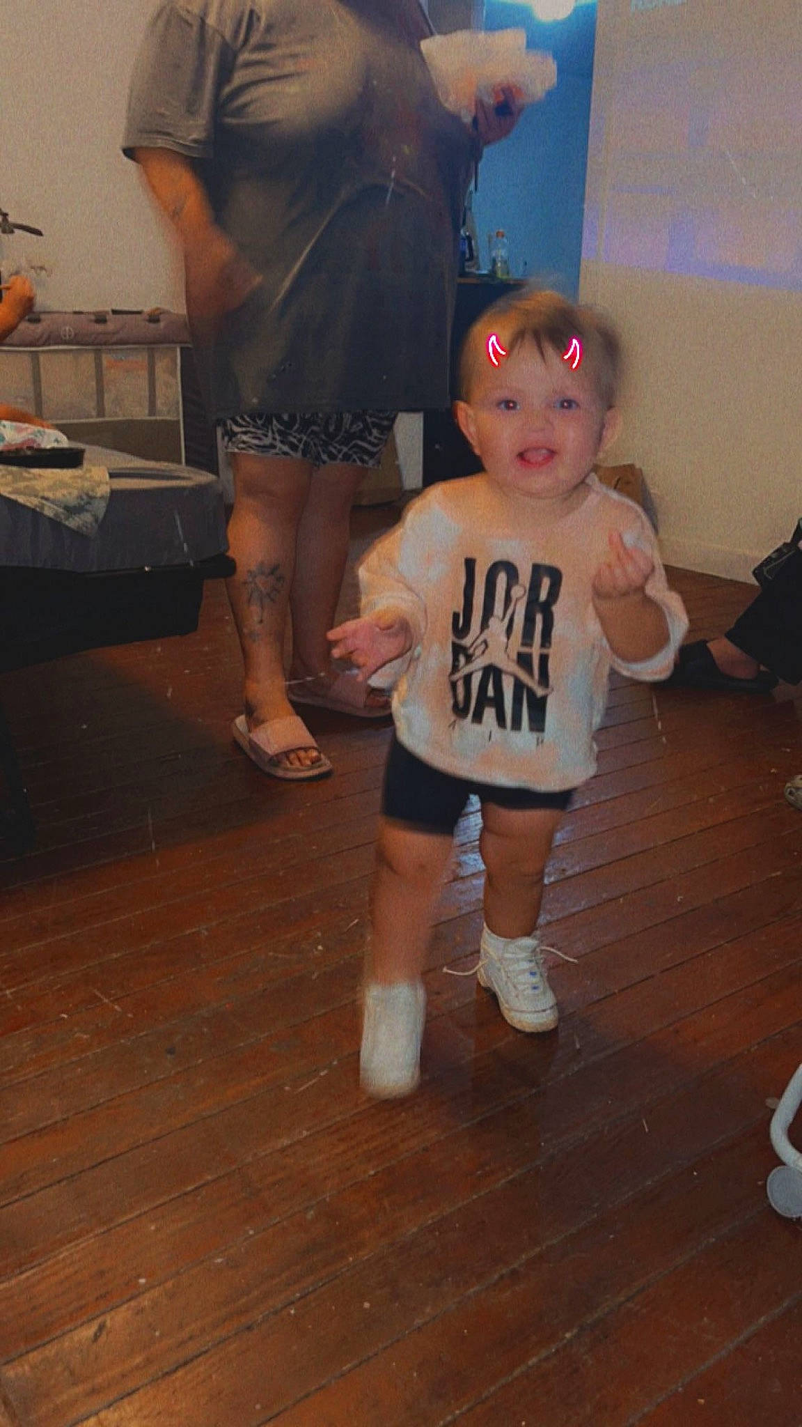 Skyler is registered to the contest to win money with this photo: baby_toddler_clothing, event, floor, flooring, fun, happy, hardwood, human_leg, joint, knee, laminate_flooring, leg, person, shorts, sportswear, thigh, thumb, toddler, trunk, wood