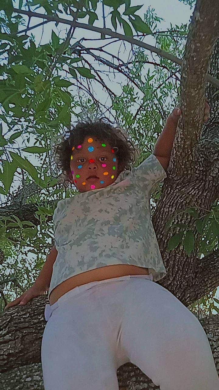 Riley joined the competition — help win amazing prizes! abdomen, child, fun, grass, happy, hat, human_leg, leisure, organism, pattern, people_in_nature, person, plant, shorts, sitting, t_shirt, thigh, tree, trunk, waist