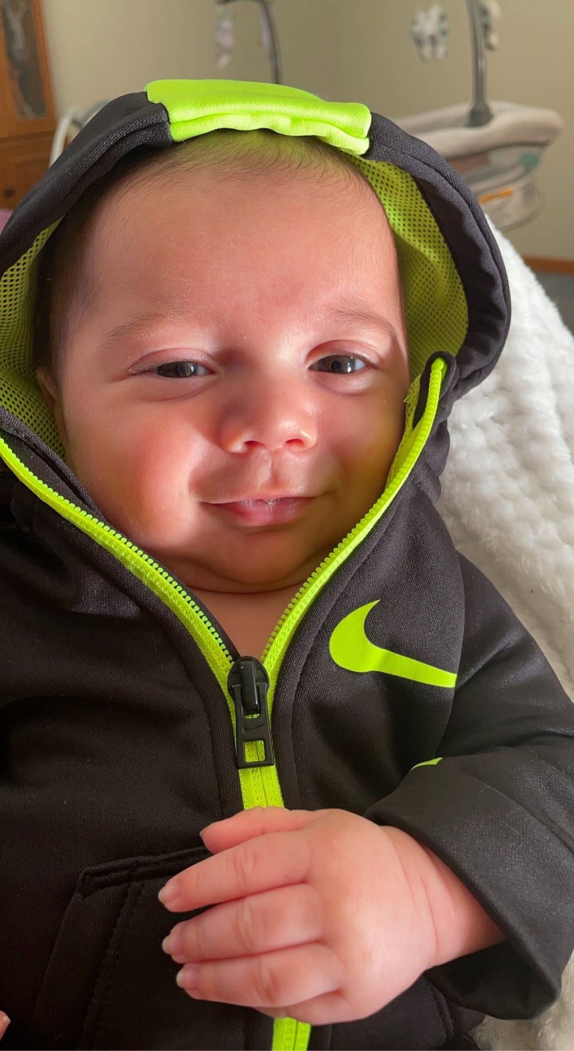 Tucker is registered to the contest to win money with this photo: baby_carriage, child, cool, eyebrow, face, facial_expression, gesture, green, happy, head, headgear, jacket, nose, organ, person, personal_protective_equipment, photograph, skin, sleeve, smile