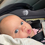 Shyanne joined the competition — help win amazing prizes! baby, car_seat, blanket, blue_eyes, infant, child, seatbelt, tattoo, face, head, clothing, person, interior, car, safety, cute, expression, closeup, young, portrait
