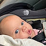 baby, car_seat, blanket, blue_eyes, infant, child, seatbelt, tattoo, face, head, clothing, person, interior, car, safety, cute, expression, closeup, young, portrait