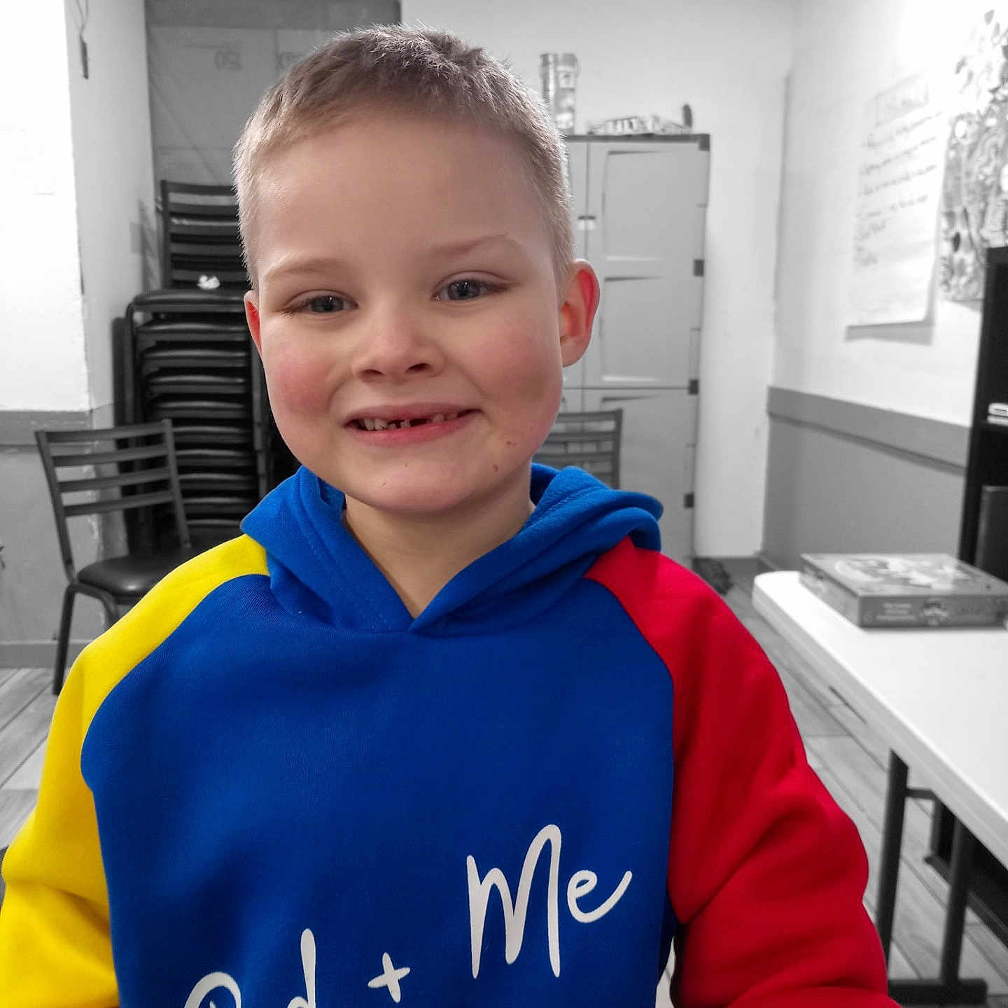 Morgan is registered to the contest to win money with this photo: boy, chair, child, clothing, coat, face, furniture, happy, head, hoodie, indoors, jacket, knitwear, male, person, photography, portrait, sweater, sweatshirt, table