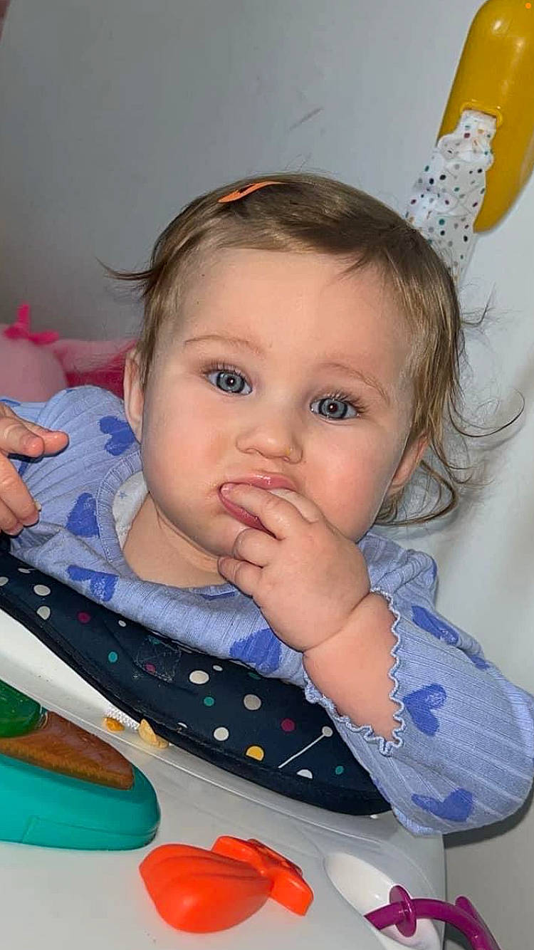 Remi is registered to the contest to win money with this photo: baby, biting, blonde, bodypart, brownhair, clothing, cosmetics, eating, face, finger, food, hair, hand, happy, head, lipstick, person, photography, portrait, smile