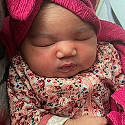 Legacii is registered to the contest to win money with this photo: baby, sleeping, infant, pink, hat, bow, blanket, floral, clothing, hand, cute, child, face, newborn, soft, warm, indoors, portrait, cozy, peaceful