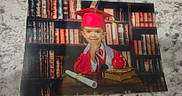 Izaiah is registered to the contest to win money with this photo: child, graduation, cap, gown, red, apple, books, library, diploma, smile, portrait, table, education, young, person, indoors, academic, celebration, desk, background
