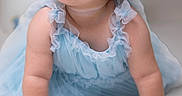 Vivienne is registered to the contest to win money with this photo: baby, blue_dress, blue_eyes, bow, brown_hair, child, crawling, cute, face, fashion, girl, hands, indoors, infant, photography, portrait, ruffles, sitting, smiling, studio