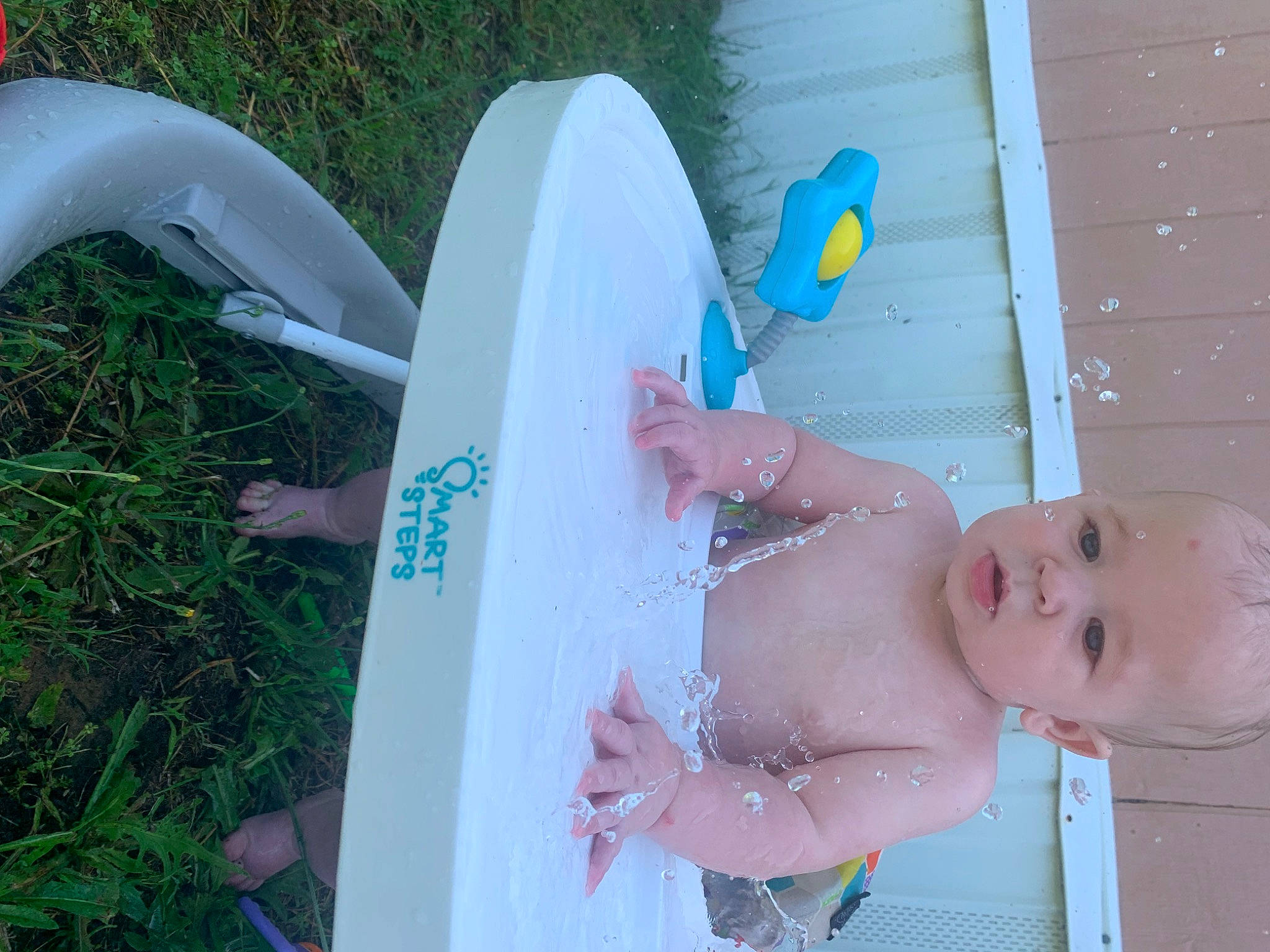 Koen is registered to the contest to win money with this photo: abdomen, azure, baby, baby_products, barechested, bathing, chest, child, fun, grass, happy, human_leg, leisure, person, recreation, surfboard, thigh, toddler, toy, vacation