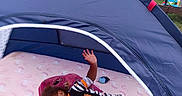 Jaleyah joined the competition — help win amazing prizes! child, toddler, sleeping, smiling, tent, play_tent, outdoor, backyard, mattress, pillow, pajamas, striped_pants, cartoon_clothing, toy, bottle, hand_raised, nap, camping, residential_area, portrait