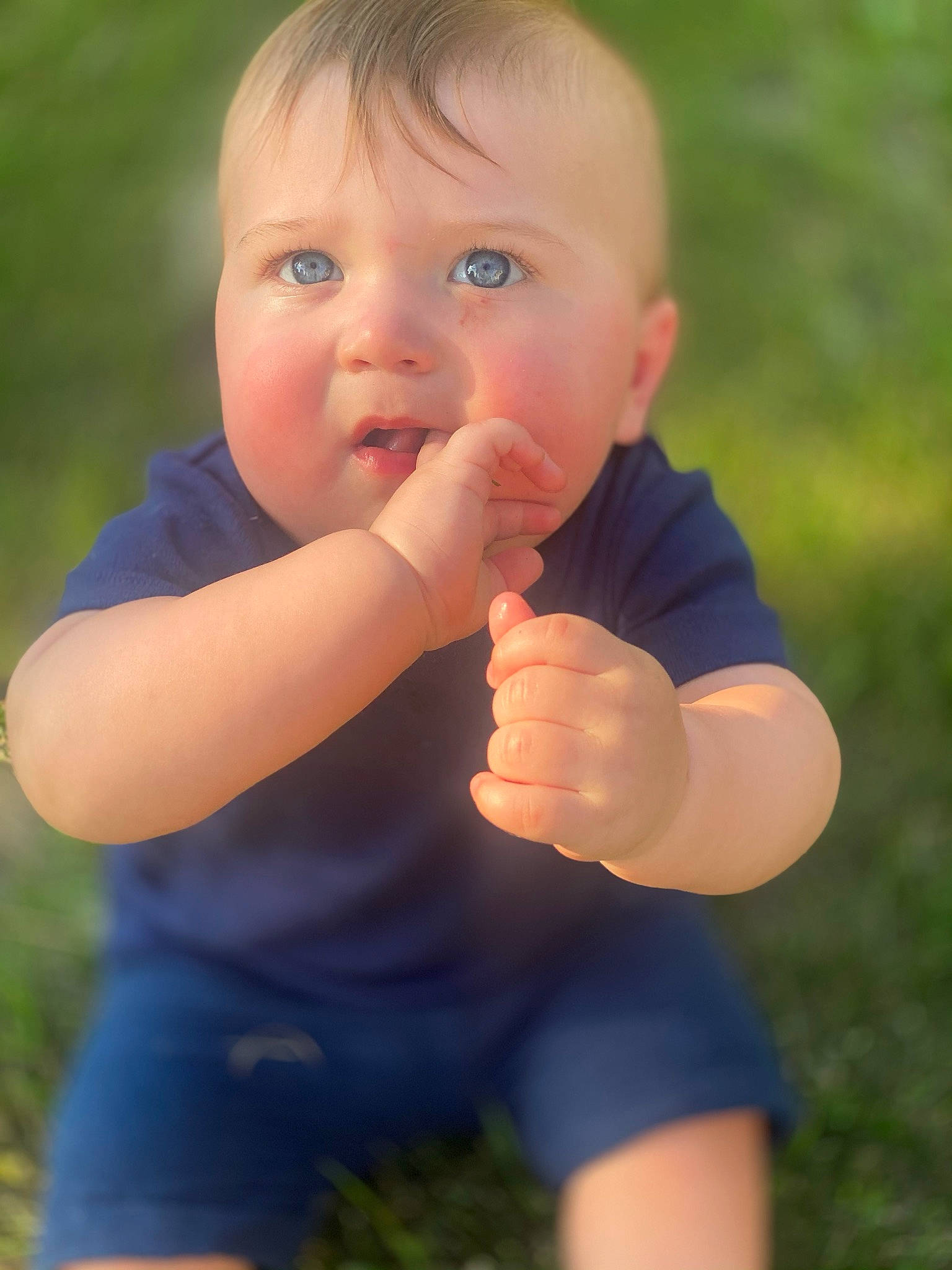 Cade is registered to the contest to win money with this photo: baby, baby_toddler_clothing, ball, finger, flash_photography, fun, gesture, grass, grass_family, hand, happy, human_body, leisure, nail, nose, people_in_nature, person, smile, summer, thumb