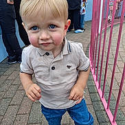 Lukas joined the competition — help win amazing prizes! toddler, child, blue_eyes, polo_shirt, jeans, sneakers, outdoor, playground, pink_fence, paved_path, curious, standing, people, casual_clothing, daylight, portrait, young_child, person, smiling, urban