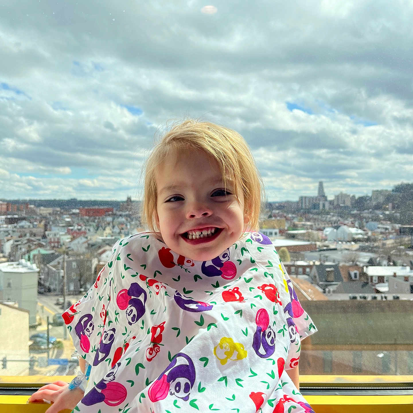 Lily is registered to the contest to win money with this photo: architecture, blouse, building, child, city, cityscape, clothing, coat, dress, face, female, girl, happy, head, highrise, person, photography, portrait, smile, urban