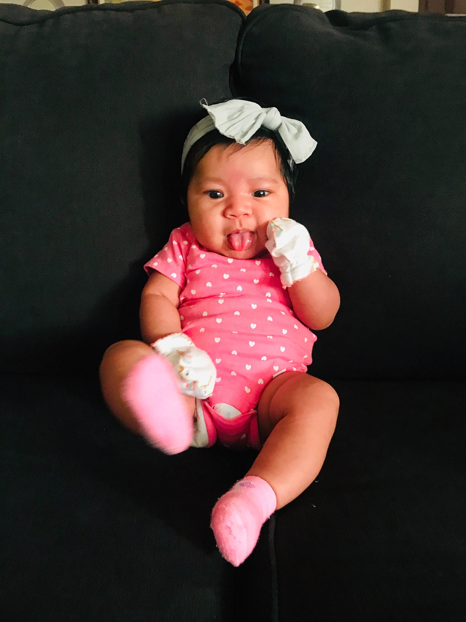 Abrielle is registered to the contest to win money with this photo: arm, baby, baby_products, baby_toddler_clothing, cheek, child, child_model, finger, hair_accessory, hand, head, headgear, person, photo_shoot, photography, pink, product, sitting, skin, smile