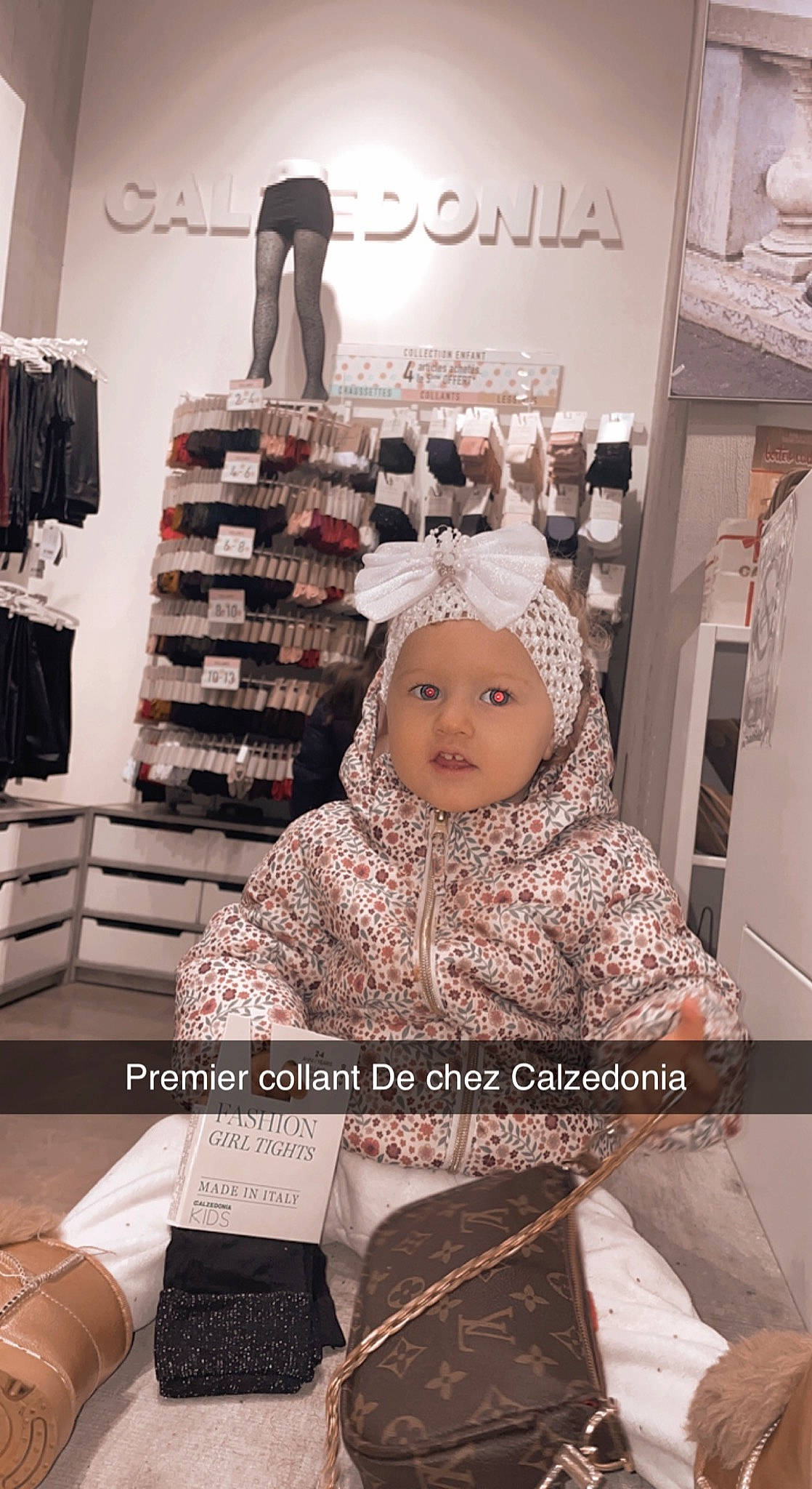 Ezra participe au concours pour gagner de l'argent avec cette photo : baby, baby_toddler_clothing, comfort, event, fashion_accessory, fashion_design, flooring, fur, happy, headwear, magenta, pattern, person, photo_caption, room, shelf, sitting, sleeve, snapshot, standing