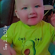 Michael joined the competition — help win amazing prizes! baby, infant, child, portrait, sitting, avocado_shirt, green_clothing, smiling, face, eyes, indoor, home, furniture, chair, table, date_stamp, close_up, casual_photo, baby_diaper, adorable