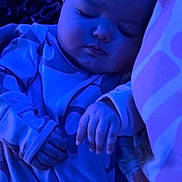 Paisley is registered to the contest to win money with this photo: baby, sleeping_baby, infant, child, asleep, pajamas, blanket, pillow, hand, face, portrait, closeup, head, cozy, cute, peaceful, night_light, blue_tint, bedding, nursery