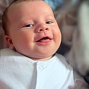 Sonny joined the competition — help win amazing prizes! baby, infant, smiling, face, white_clothing, portrait, closeup, cute, child, happy, skin, head, eyes, mouth, indoors, newborn, expression, human, soft_light, peaceful