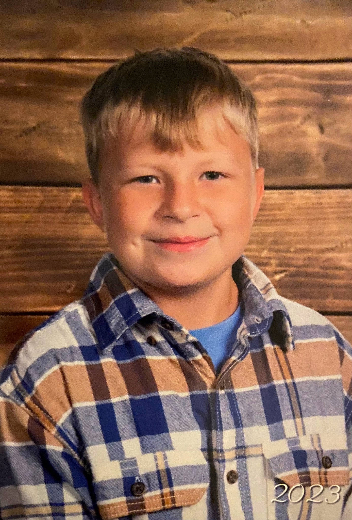 Kyler is registered to the contest to win money with this photo: brown_hair, cheek, child, chin, collar, dress_shirt, eye, face, flash_photography, forehead, fun, happy, head, joy, nose, pattern, person, plaid, sleeve, smile