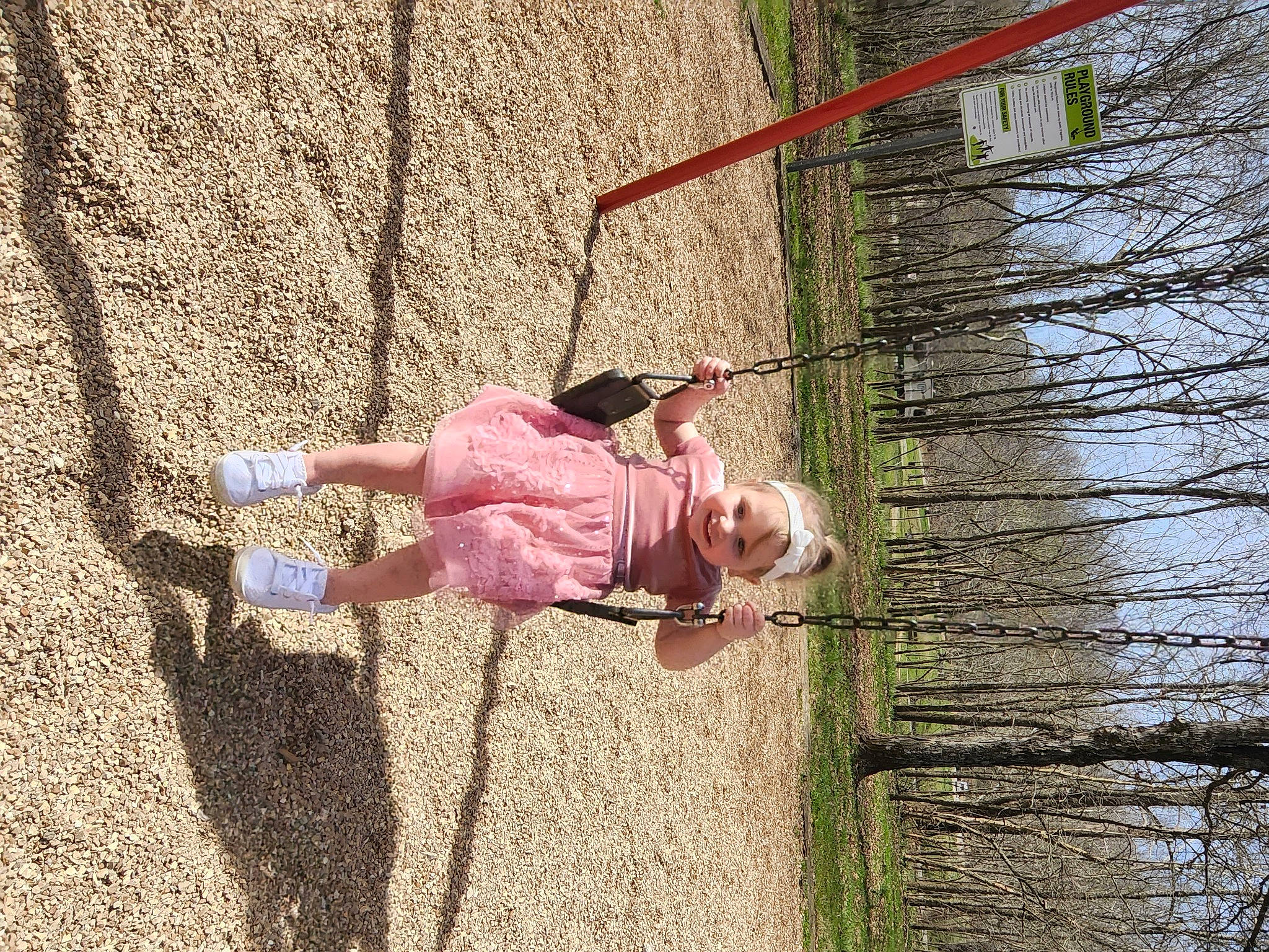 Lani is registered to the contest to win money with this photo: child, fun, grass, headwear, joy, landscape, leisure, magenta, outdoor_play_equipment, people_in_nature, person, plant, play, playground, recreation, rope, shadow, soil, swing, toddler