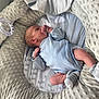 baby, baby_bedding, baby_lounger, blue_onesie, child, cozy, cute, indoor, infant, newborn, nursery, pacifier, peaceful, plush, portrait, resting, sleeping, soft_texture, striped_socks, stuffed_animal