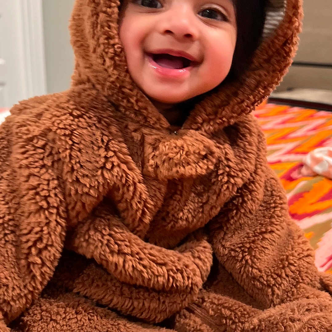 Ayra joined the competition — help win amazing prizes! baby, bear, bedspread, child, clothing, costume, cute, face, fuzzy, happy, hood, indoors, infant, person, portrait, sitting, smiling, soft, warm, young