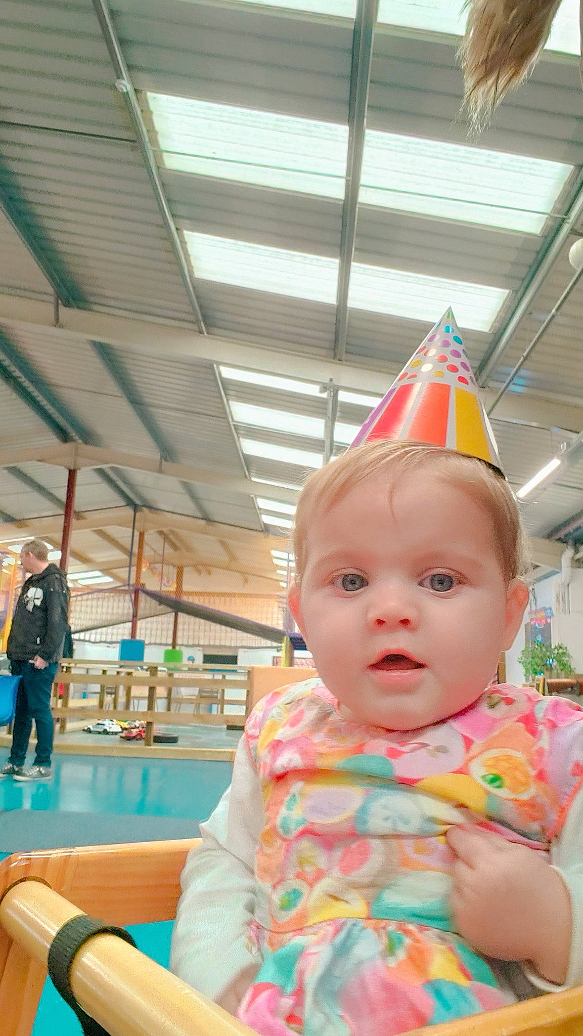 Arya is registered to the contest to win money with this photo: baby, baby_toddler_clothing, chair, child, cone, costume_hat, fashion_accessory, flooring, fun, happy, hat, kindergarten, leisure, party_hat, party_supply, person, play, recreation, room, surprise