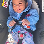 Adonis joined the competition — help win amazing prizes! baby, child, car_seat, blue_hoodie, smiling, happy, infant, seatbelt, clothing, cute, portrait, indoor, safety, straps, toddler, colorful_pants, spiderman, hands, face, hood