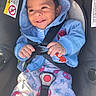baby, child, car_seat, blue_hoodie, smiling, happy, infant, seatbelt, clothing, cute, portrait, indoor, safety, straps, toddler, colorful_pants, spiderman, hands, face, hood