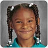 Quiari is registered to the contest to win money with this photo: child, girl, smile, portrait, braids, hair_beads, blue_shirt, school_photo, face, happy, person, headshot, young, cute, background, studio, expression, childhood, innocence, casual
