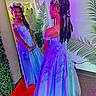 Quiari is registered to the contest to win money with this photo: child, girl, dress, mirror, reflection, braids, flower_crown, indoor, plants, red_carpet, lighting, portrait, smile, decor, floor, wall, fashion, young, happy, posing