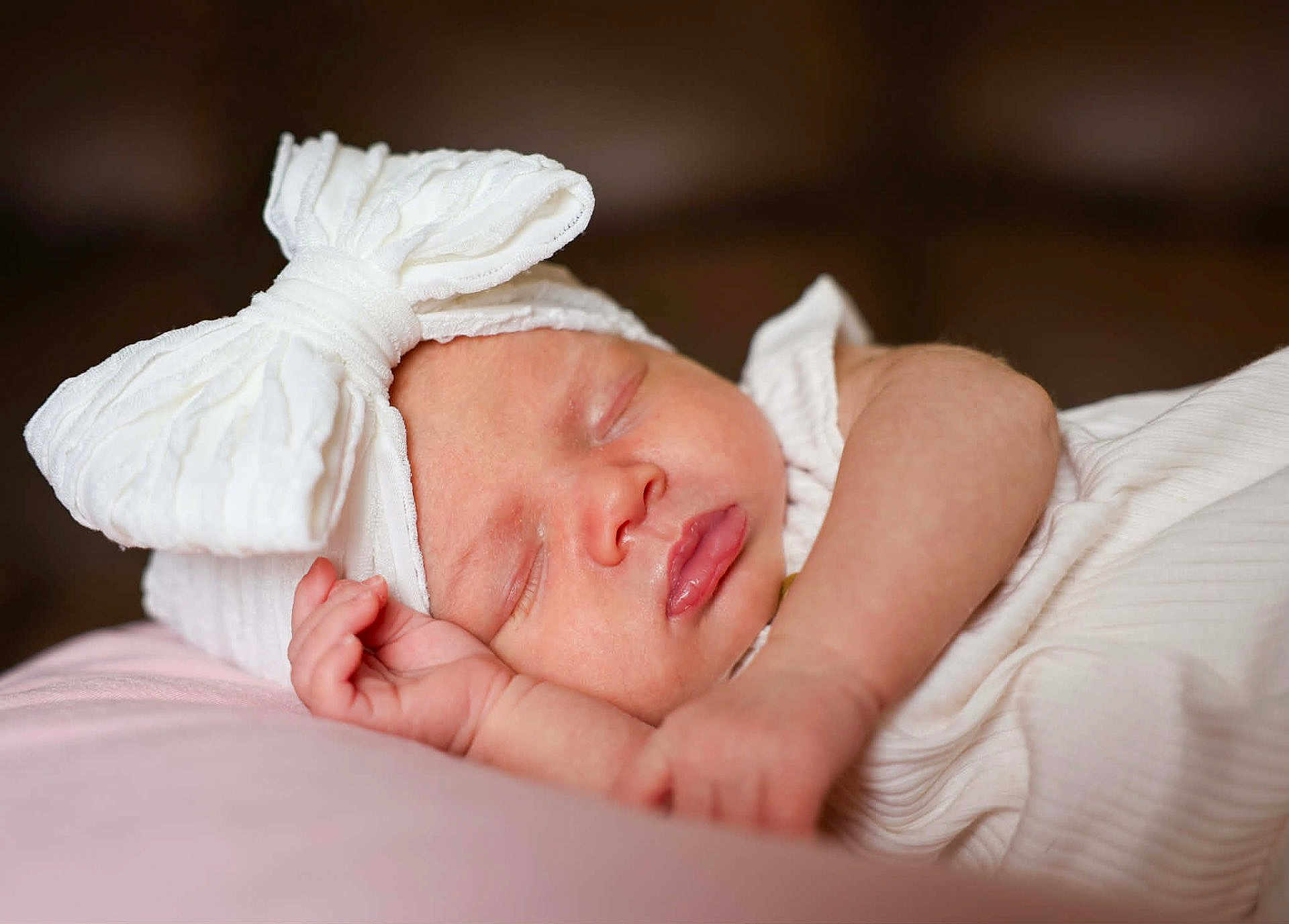 Izabella joined the competition — help win amazing prizes! baby, newborn, sleeping, headband, bow, infant, close_up, portrait, pillow, soft_texture, peaceful, skin, hand, lips, cheek, blanket, white_clothing, nursery, indoor, cute