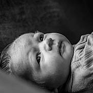 Izabella joined the competition — help win amazing prizes! baby, infant, newborn, face, eye, cheek, portrait, black_and_white, monochrome, close_up, gaze, lying_down, clothing, fabric, soft_texture, hair, eyelashes, head, skin, sleepy