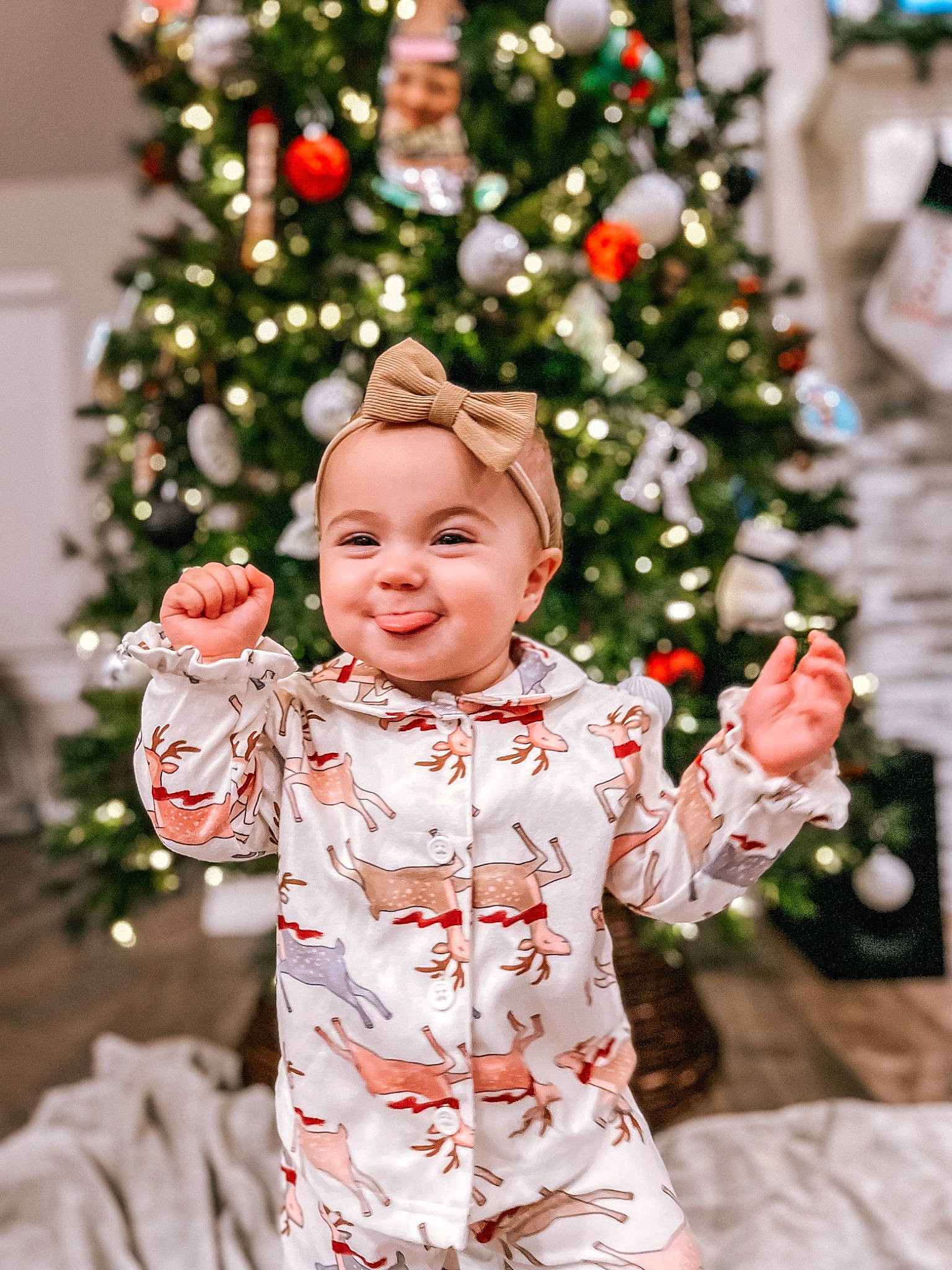 Amelia is registered to the contest to win money with this photo: baby, baby_toddler_clothing, christmas_decoration, christmas_ornament, christmas_tree, event, evergreen, facial_expression, fun, happy, headwear, holiday, holiday_ornament, joy, leaf, ornament, people_in_nature, person, sleeve, smile