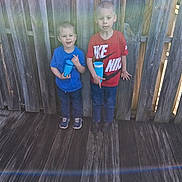 Dillon joined the competition — help win amazing prizes! children, boys, siblings, portrait, outdoor, wooden_deck, fence, smiling, standing, blue_shirt, red_shirt, sportswear, nike_shirt, cup, drink, shoes, short_hair, backyard, daylight, casual