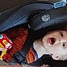 child, toddler, car_seat, passenger, automobile, indoors, portrait, face, open_mouth, brown_hair, sitting, harness, safety_belt, toy, colorful, curious, camera, vehicle, travel, family