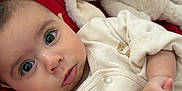 Dahlia Mila is registered to the contest to win money with this photo: baby, bunny, child, closeup, clothing, cute, expression, eyes, face, hands, indoors, infant, lying_down, person, plush_toy, portrait, red_blanket, resting, soft_toy, stuffed_animal
