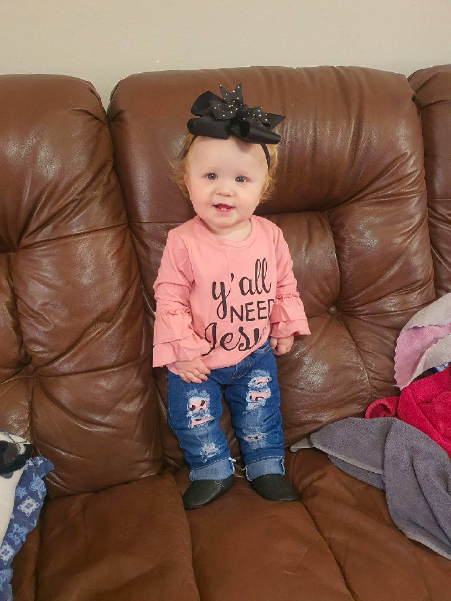 Oaklynn joined the competition — help win amazing prizes! baby_toddler_clothing, brown, cheek, comfort, couch, facial_expression, floor, flooring, fun, furniture, hair, head, headwear, lap, living_room, mouth, person, sleeve, smile, textile