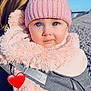 baby, child, hat, pink, pom_pom, jacket, fluffy, blue_eyes, person, outdoor, beach, sky, pebble, portrait, closeup, winter_clothing, carrier, warm, cute, face