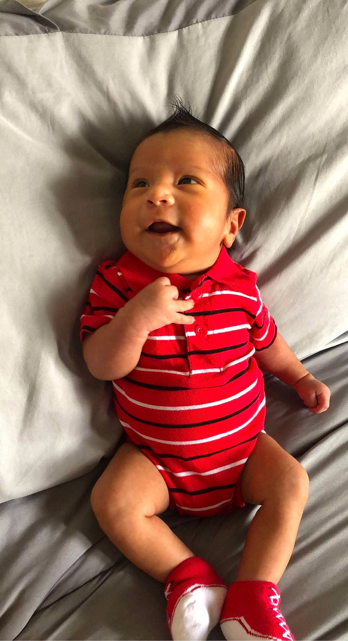 Zayden is registered to the contest to win money with this photo: arm, baby_toddler_clothing, cheek, chin, comfort, eyebrow, flash_photography, gesture, head, human_body, iris, joint, lip, mouth, neck, nose, organ, person, skin, sleeve